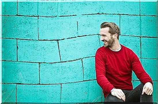 man in front of green wall