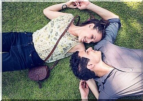 couple lying on the grass