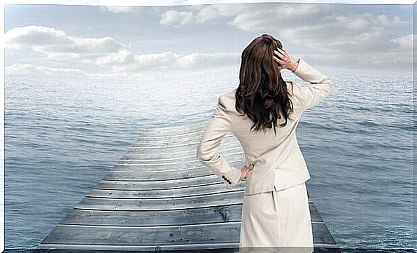 Woman on pier in front of the sea