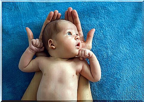 Curious baby in mother's arms