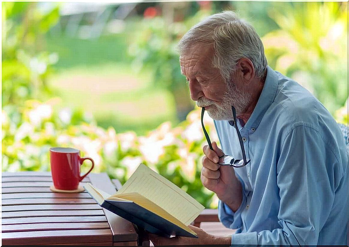 old man reading a book