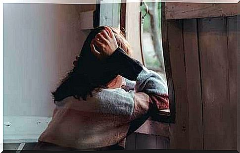 woman sitting in front of the window