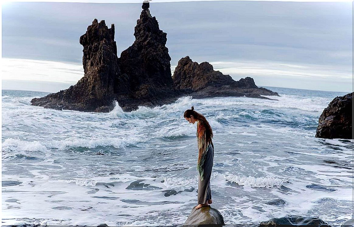 Stone woman on the seashore