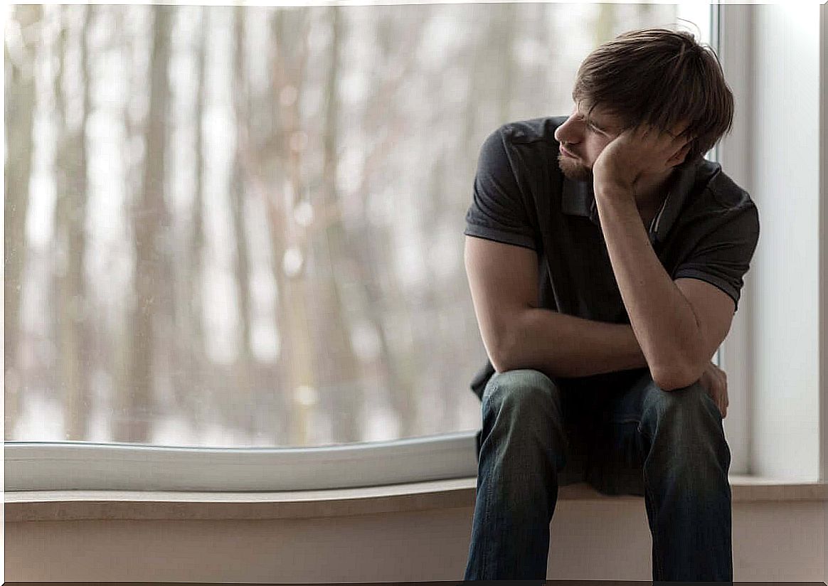 thoughtful man in front of window