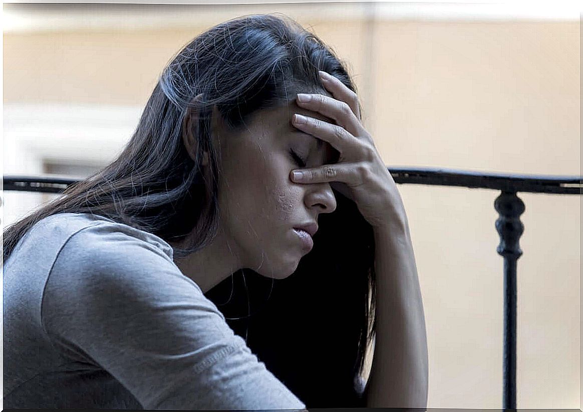 Worried woman with hand on face