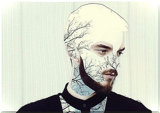 man with branches on his face