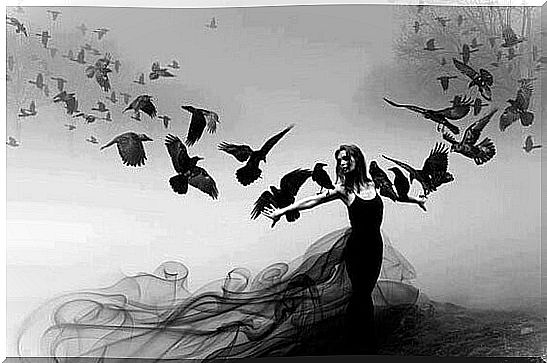 woman with crows flying around her