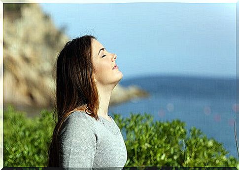 Woman breathing fresh air amidst nature