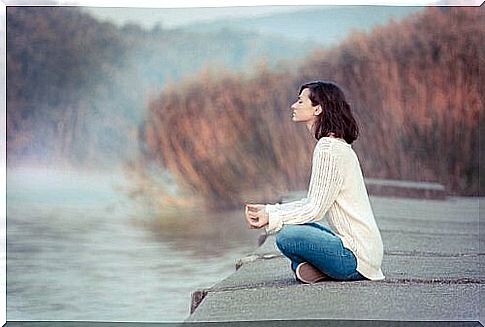 Woman meditating to clear away mental fog